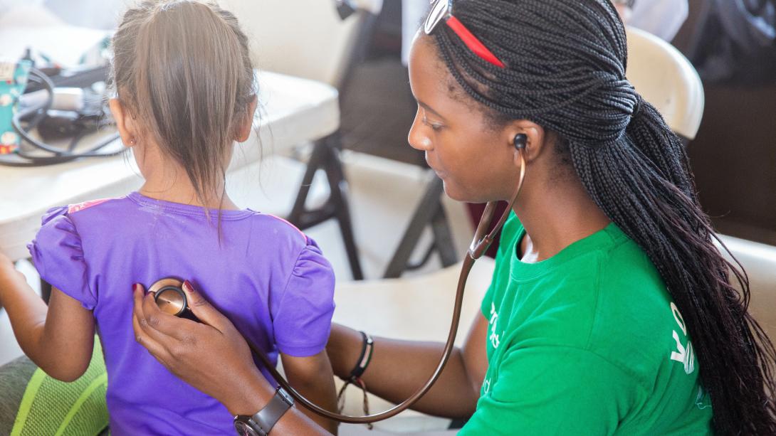 A local child has her vitals checked by a college volunteer on a medical outreach in Mexico. On a volunteering abroad project for college students in Mexico, a child's heart rate is checked.